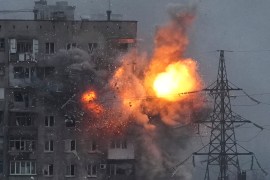 An explosion in an apartment building that came under fire from a Russian army tank in Mariupol, Ukraine,