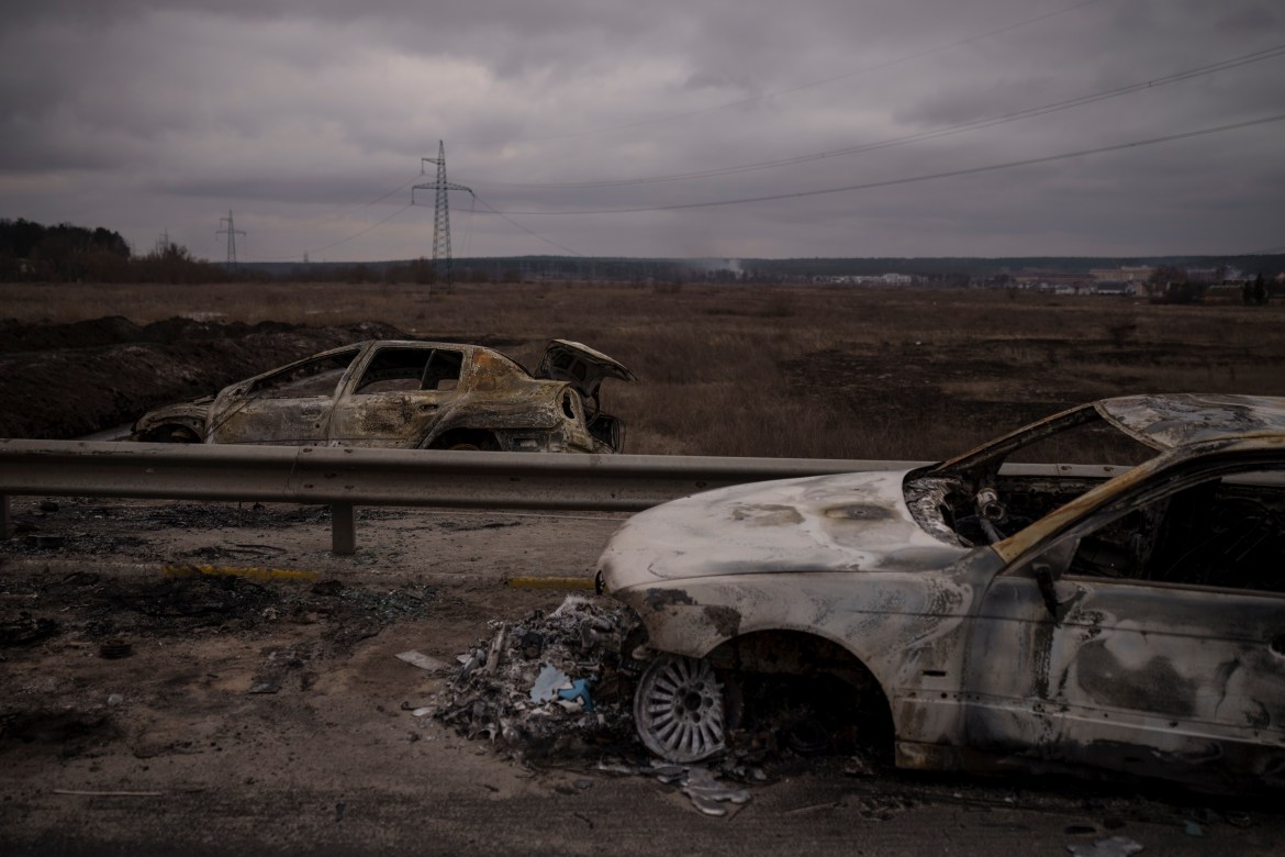 Destroyed cars on a road being used as an evacuation route out of Irpin, on the outskirts of Kyiv