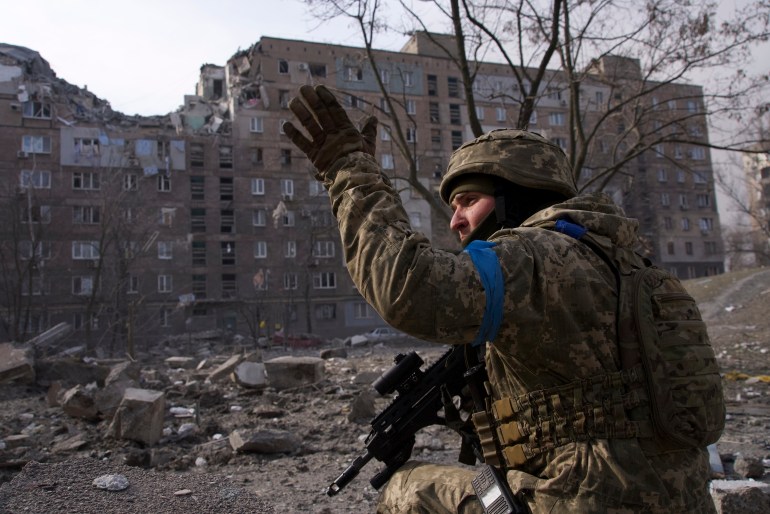 A Ukrainian serviceman guards his position in Mariupol