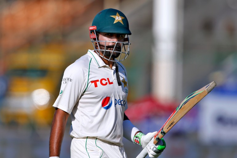 Pakistan's Babar Azam walks back to pavilion after his dismissal on 196 runs