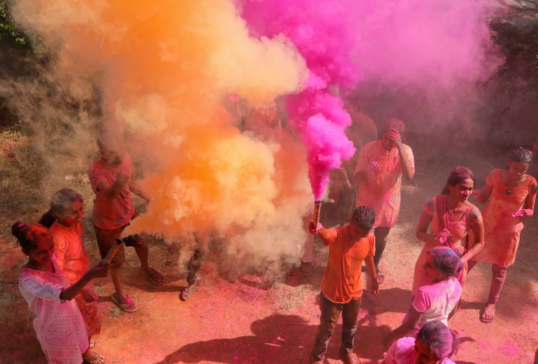People celebrate Holi, the Hindu festival of colors, in Hyderabad, India, Friday, March 18, 2022. Holi also heralds the arrival of spring. (AP Photo/Mahesh Kumar A.)