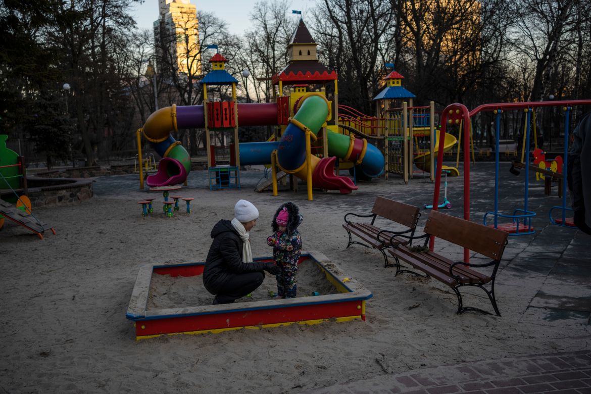 Olga plays with her daughter Vedeneya in an empty park in Kyiv