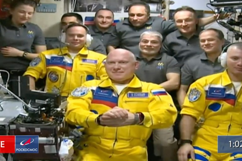 In this frame grab from video provided by Roscosmos, Russian cosmonauts Sergey Korsakov, Oleg Artemyev and Denis Matveyev are seen during a welcome ceremony after arriving at the International Space Station, Friday, March 18, 2022, the first new faces in space since the start of Russia’s war in Ukraine.
