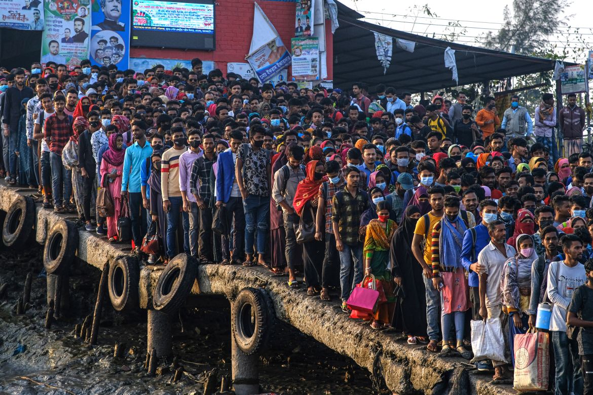 Workers gather in the morning at a boat terminal, waiting to cross the Mongla river, in Mongla, Bangladesh