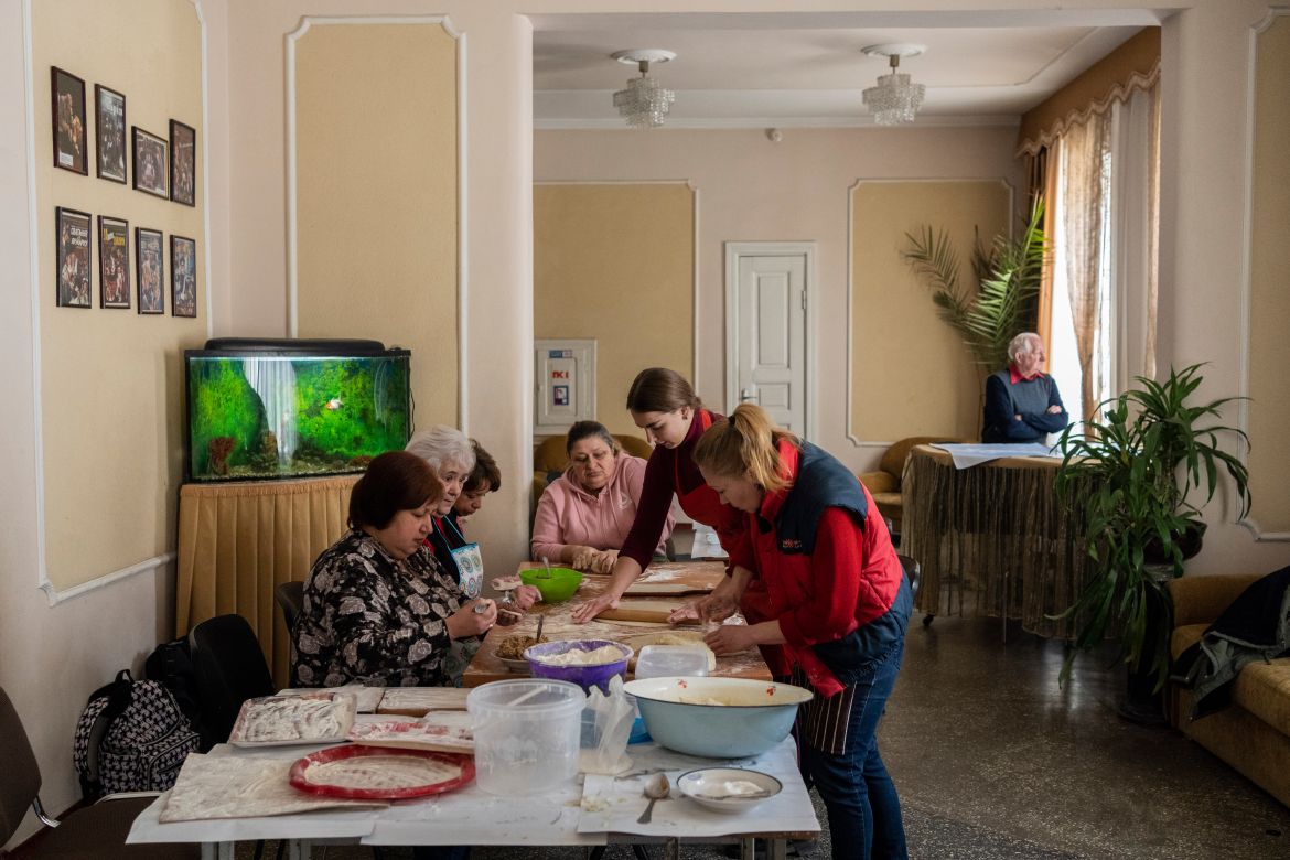 Volunteers prepare varenyky, stuffed dumplings, inside a theatre in the city of Drohobych