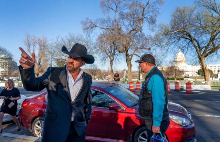 Otero County Commissioner Couy Griffin gestures before getting into a car after the first day of his trial in federal court in Washington, DC.
