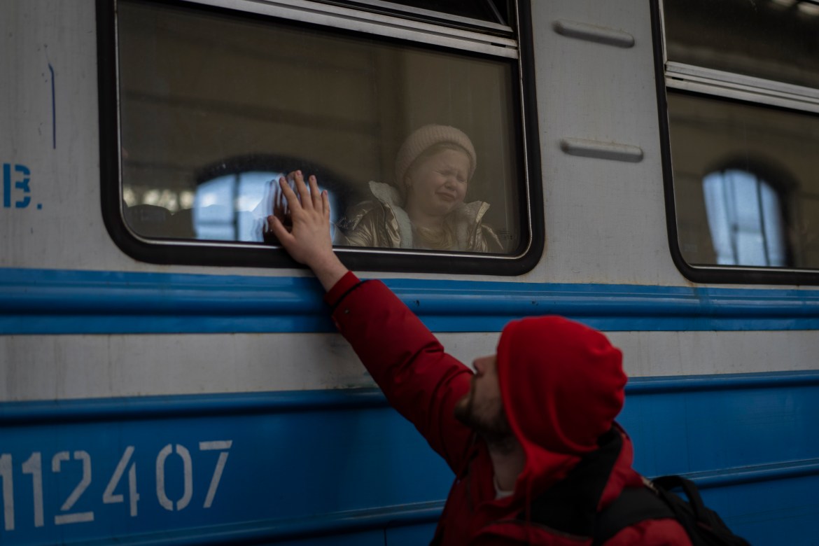 Displaced Ukrainians on a Poland-bound train bid farewell in Lviv