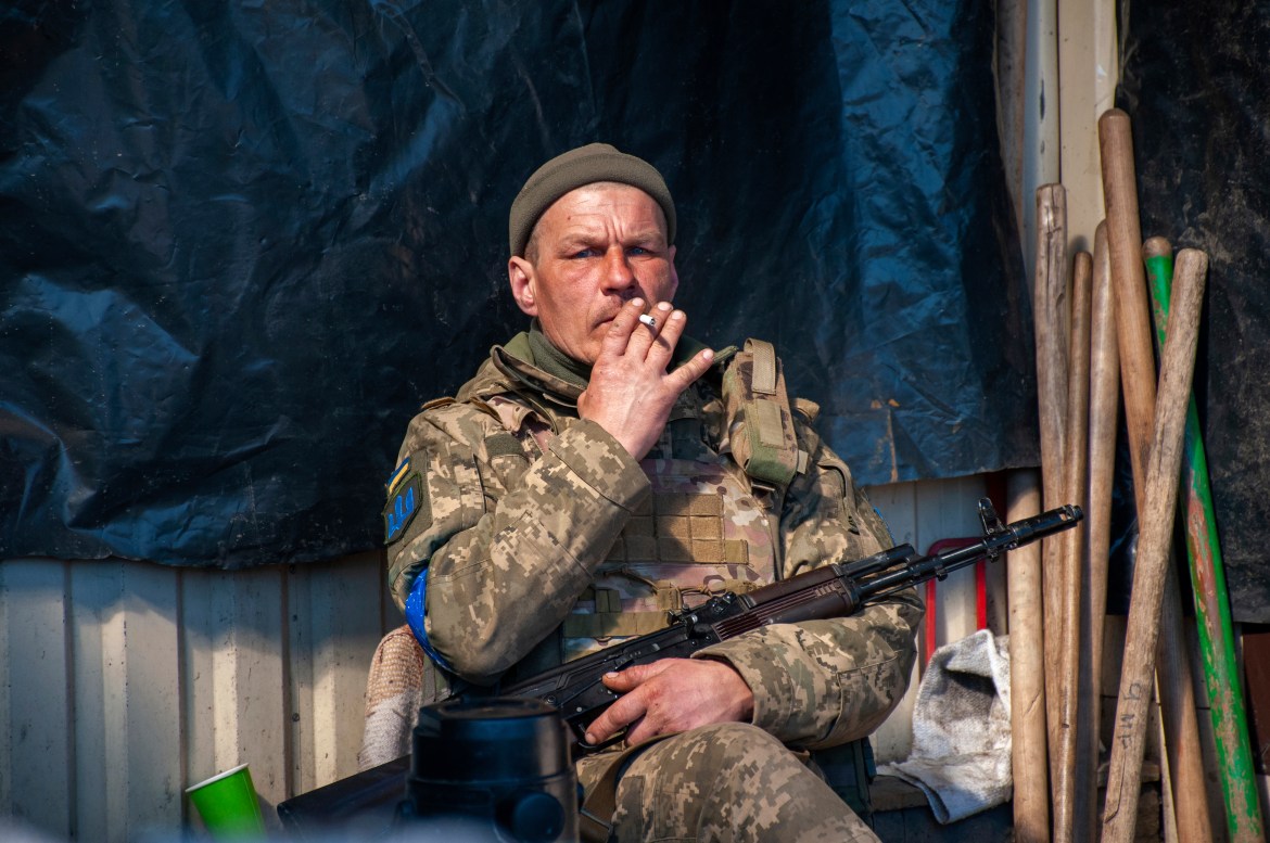A Ukrainian serviceman rests astatine  his presumption   successful  Kharkiv
