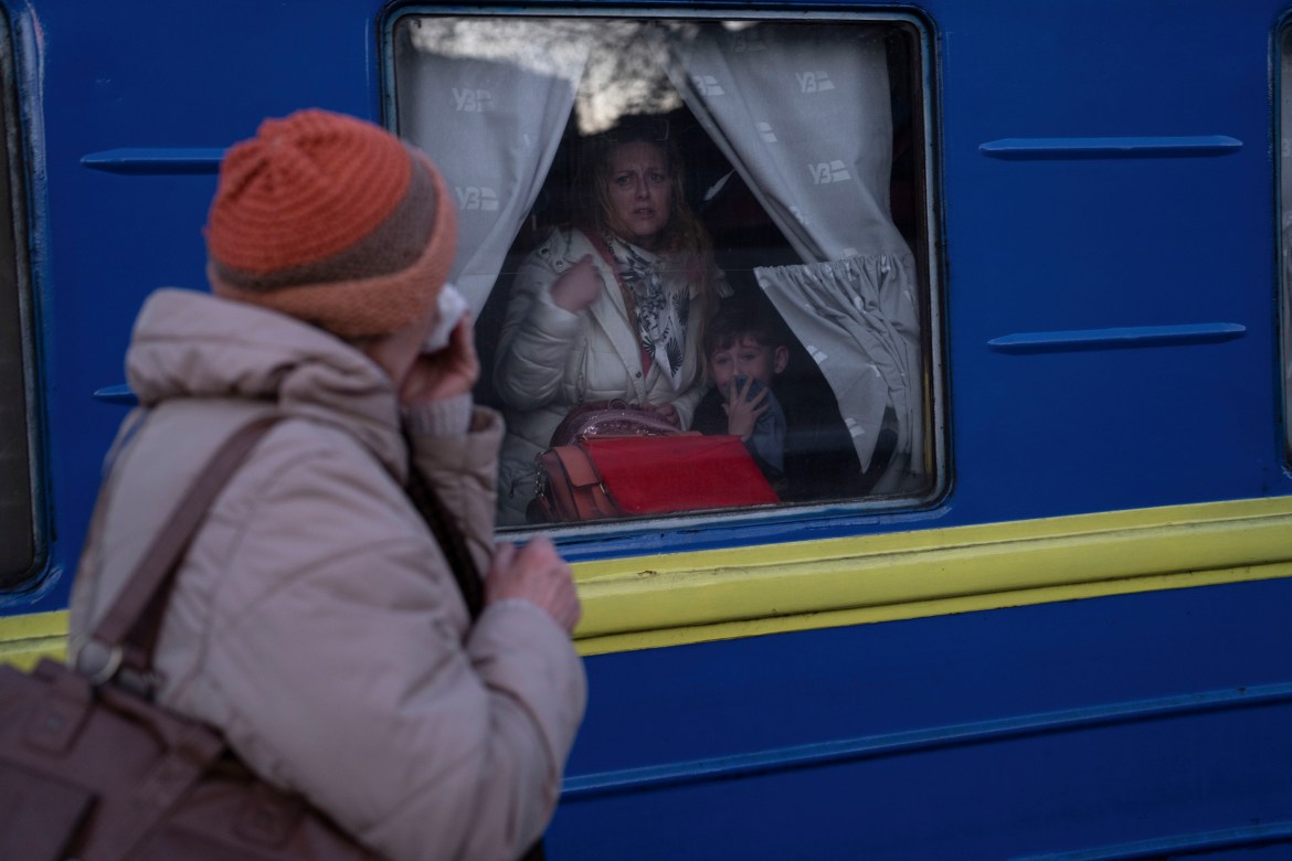Ludmila, left, says goodbye to her granddaughter Kristina, who with her son Yaric, leave the train station in Odesa