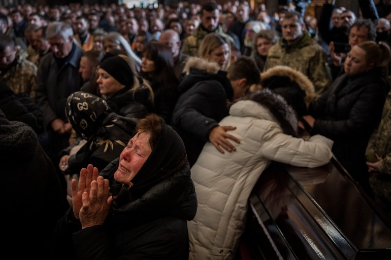 FILE - Relatives and friends attend a funeral ceremony for four of the Ukrainian military servicemen, who were killed during an airstrike in a military base in Yavoriv, in a church in Lviv, Ukraine, Tuesday, March 15, 2022. (AP Photo/Bernat Armangue, File)