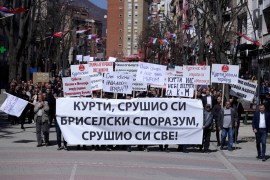 Kosovo Serbs with anti-government banners protest in Mitrovica to pressure the government into allowing them to vote in neighbouring Serbia's April 3 election