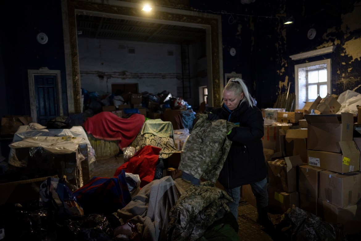 A volunteer folds army clothes inside a Ukrainian volunteer center in Mykolaiv