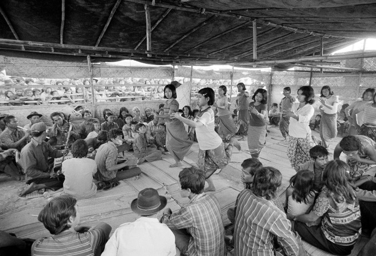 Cambodian women perform a classic Cambodian ballet at this border camp in Khao-I-Dang, Thailand on December 14, 1979. The tent was surrounded by curious Cambodians who watched the performance.