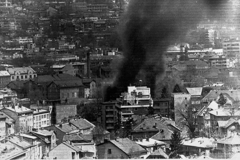 Smoke billows from a burning building in Sarajevo in 1992