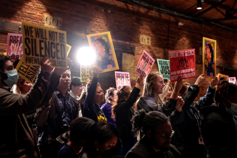 Attendees hold up signs as they during the “The Asian Justice Rally - Break the Silence” event at the Georgia Railroad Freight Depot on March 16, 2022 in Atlanta, Georgia. 