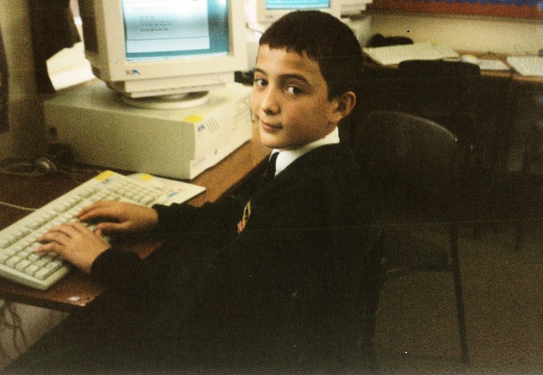 A photo of Hasan Rrahmani as a child on a computer.