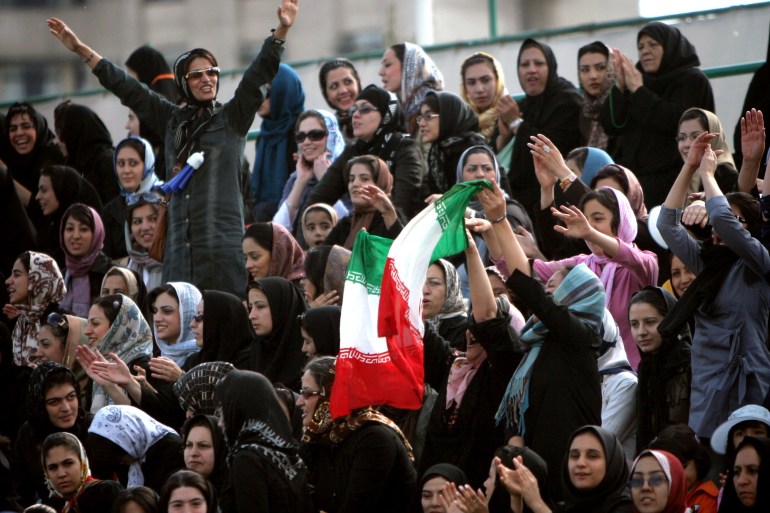 Iranian fans shout slogans in support of Iran's national women's soccer team