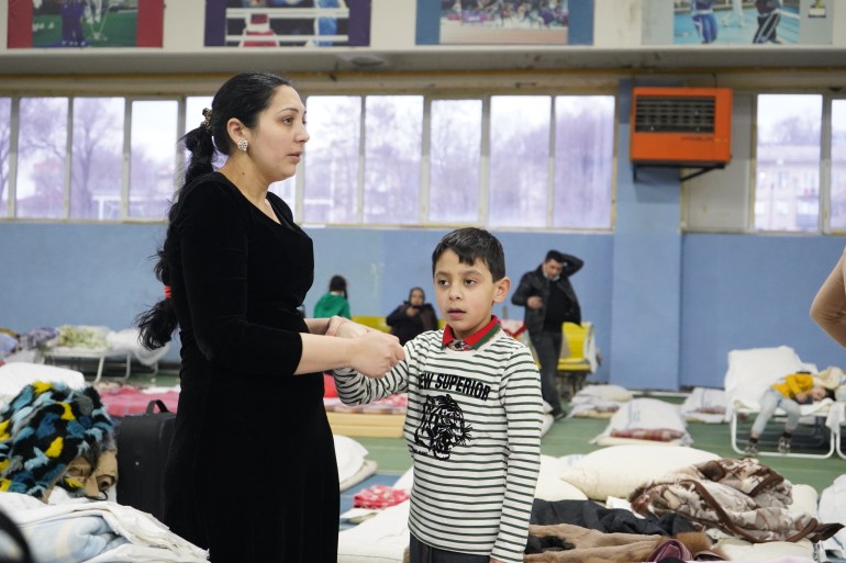 Roma refugee and her son in a sport hall in Chisinau, Moldova