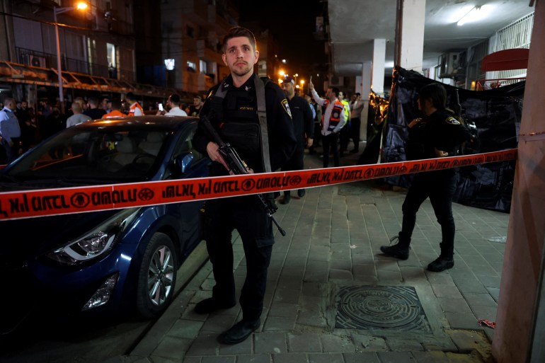 Israeli security officials secure the scene of a fatal shooting
