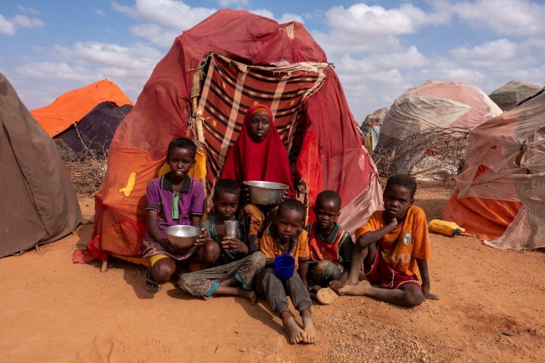 9-year-old Noradin, four of his siblings and his mother Owliyo, outside their make-shift tent near Dollow town, Somalia