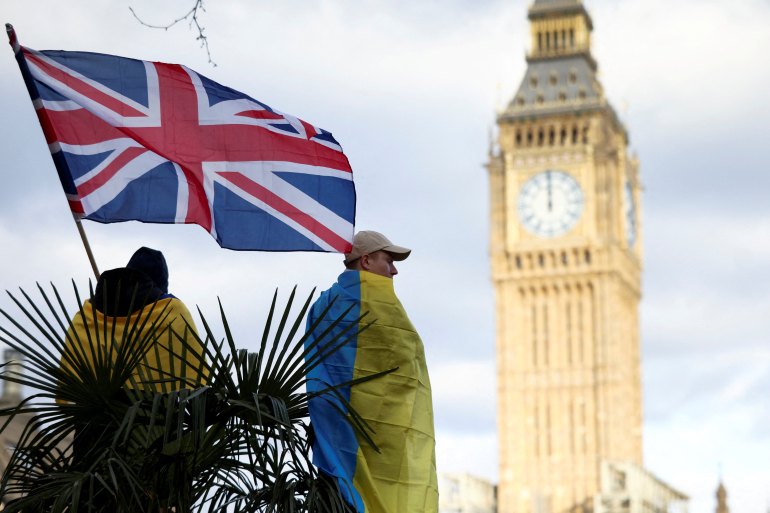 A demonstrator holds a British flag during a protest against Russia's invasion of Ukraine, at Parliament Square in London, Britain