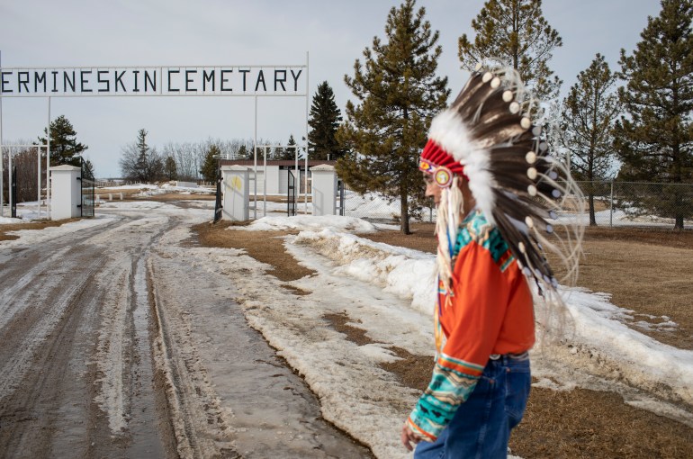 A photo of Chief Willie Littlechild walking towards Ermineskin Cemetary.