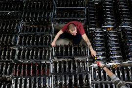 Employees work on bitcoin mining computers at Bitminer Factory in Florence, Italy