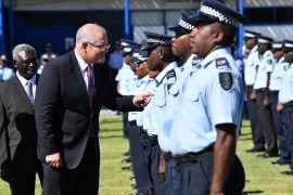 Australian PM Scott Morrison reviews a group of Solomon Islands police after arriving in the country in 2019