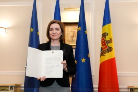 Moldovan President Maia Sandu poses with the document for the media in the State Residence building in Chisinau, Moldova