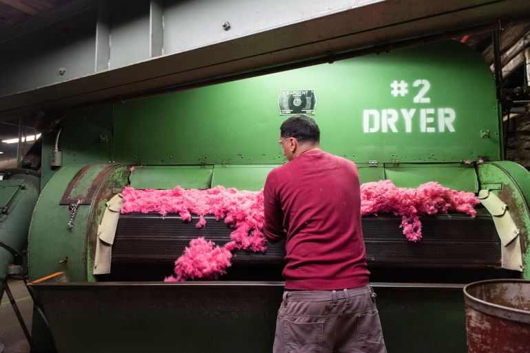 A worker checks dried dyed fiber at a raw stock dye house in Philadelphia