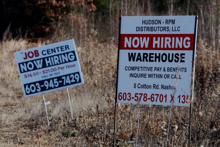 "Now Hiring" signs for jobs stand along a road in Londonderry, New Hampshire, U.S.