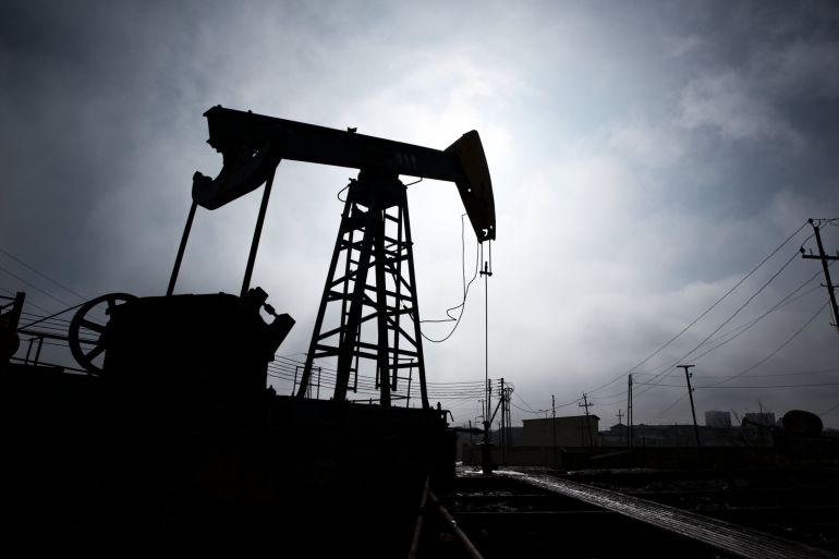 A pumpjack is silhouetted