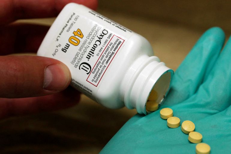 A pharmacist holds prescription painkiller OxyContin, 40mg pills, made by Purdue Pharma