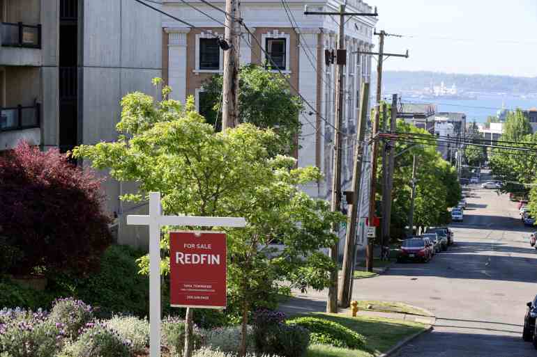 A "For Sale" sign is posted outside a residential home in the Queen Anne neighborhood of Seattle, Washington, U.S.