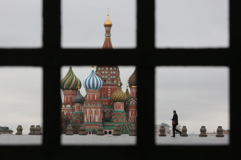 A pedestrian walks in Red Square near the Kremlin in Moscow