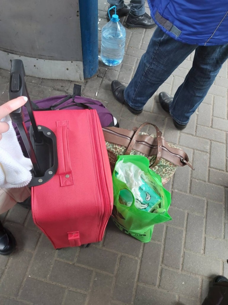 Zakhida Adylova red suitcase and other bags packed by the family