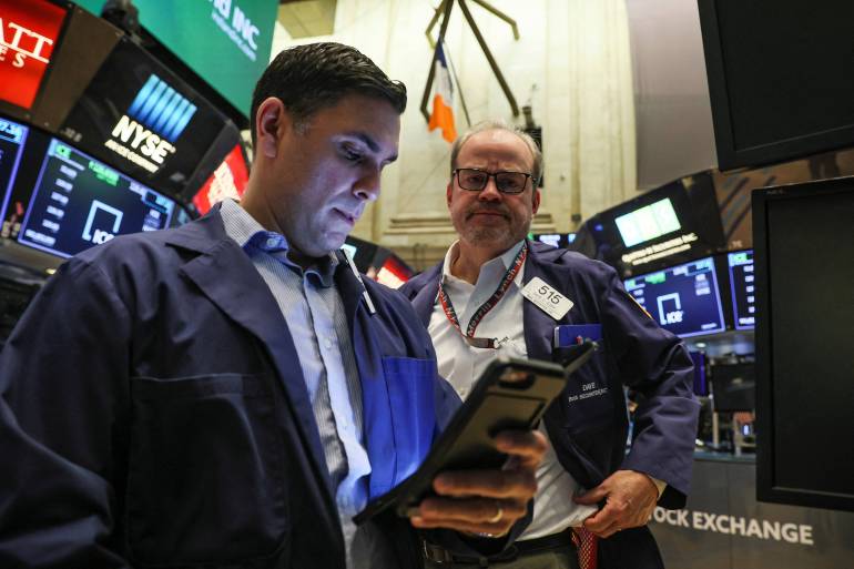 Traders work on the floor of the New York Stock Exchange in New York City, US