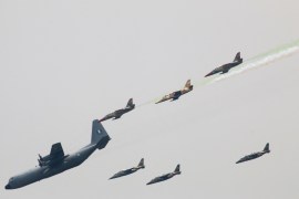 Nigerian Air Force planes perfom during a military parade marking the country's 58th anniversary of independence, on October 1, 2018