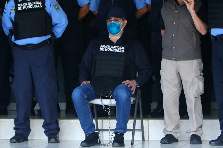 ex-Honduran President Juan Orlando Hernandez is seen handcuffed at the headquarters of the Honduras Police.