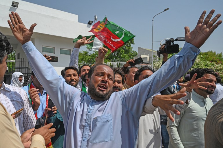 Supporters of Pakistan Tehreek-e-Insaf (PTI) party of Prime Minister Imran Khan shout slogans outside the Parliament House building in Islamabad
