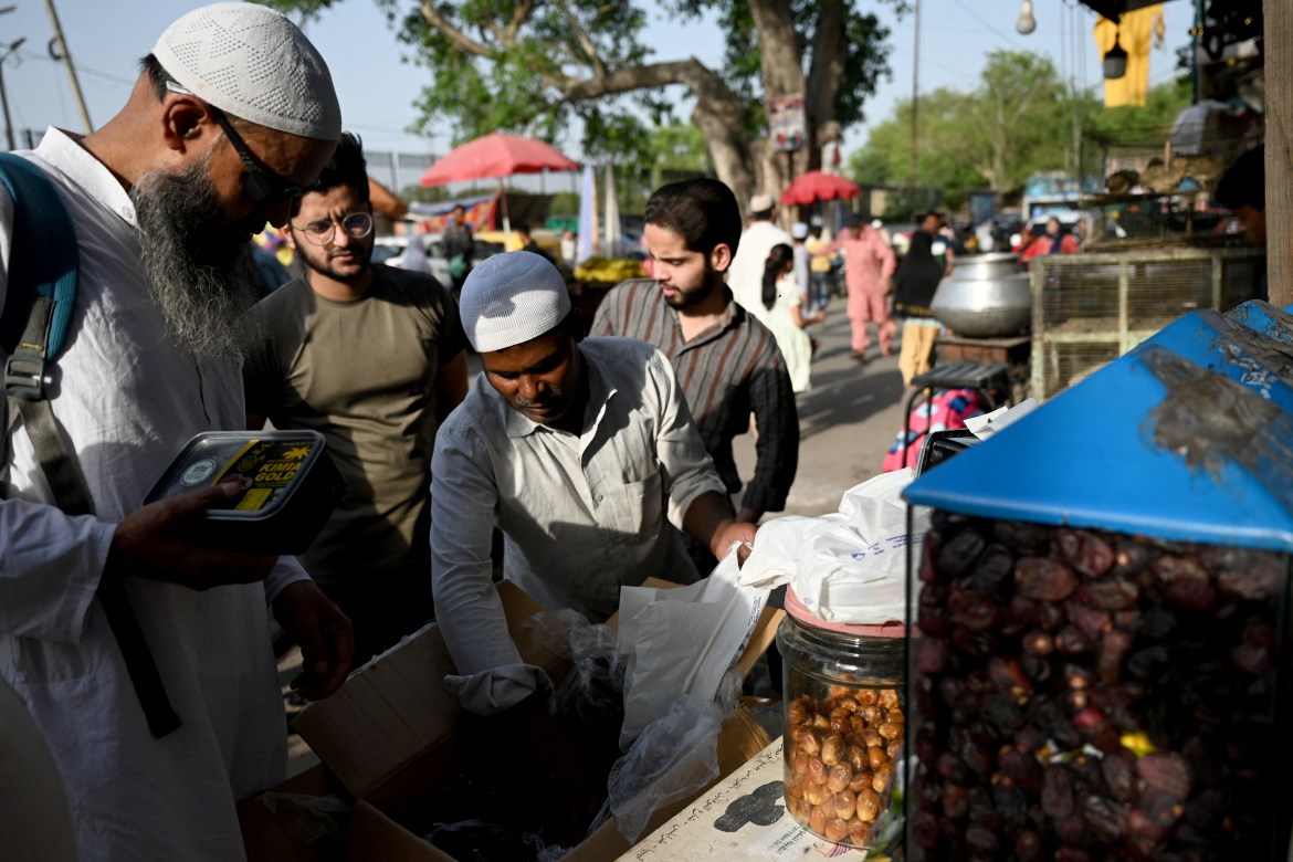 People buy dates from a roadside vendor