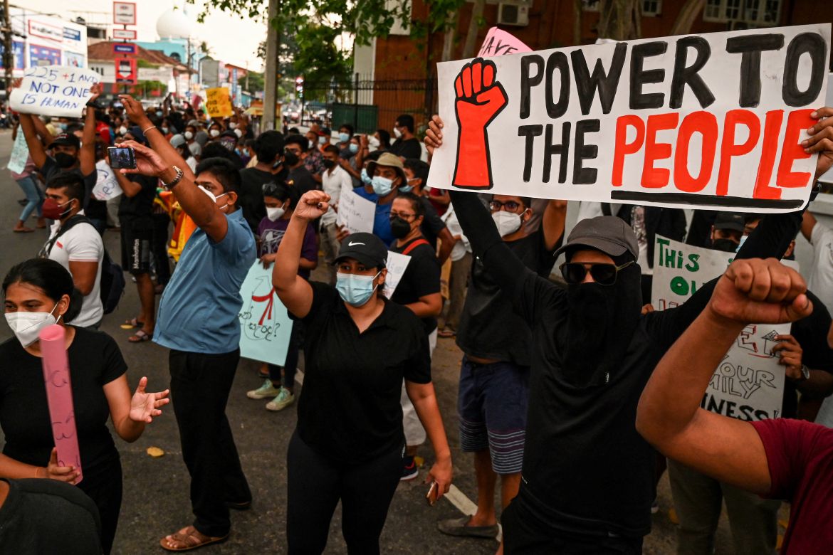 Protestors hold banners and placards during a demonstration against the surge in prices and shortage of fuel and other essential commodities in Colombo