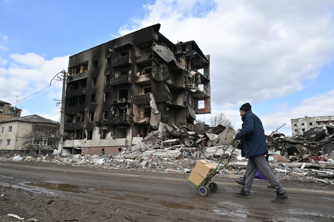 People walk past destroyed buildings in the town of Borodyanka, Ukraine.