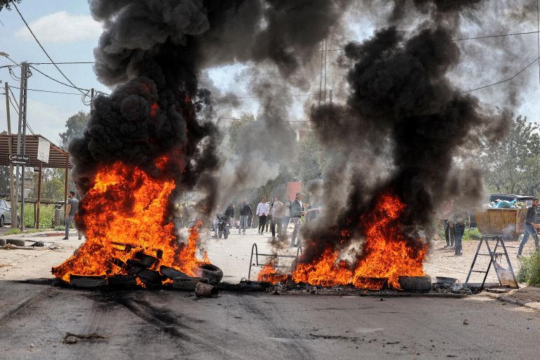 Tires are set aflame during clashes