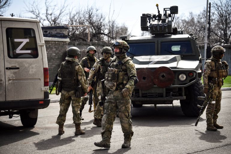 Russian soldiers patrol a street on April 11, 2022, in Volnovakha in the Donetsk region of Ukraine.