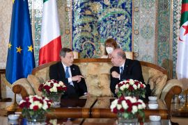 Italian Prime Minster Mario Draghi (L) speaks with Algerian Prime Minister and Minister of Finance Aymen Benabderrahmane