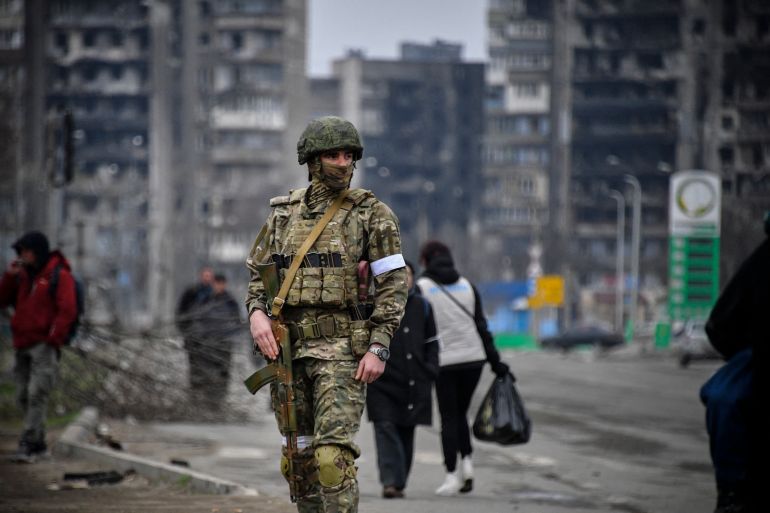 A Russian soldier is seen on patrol in Mariupol