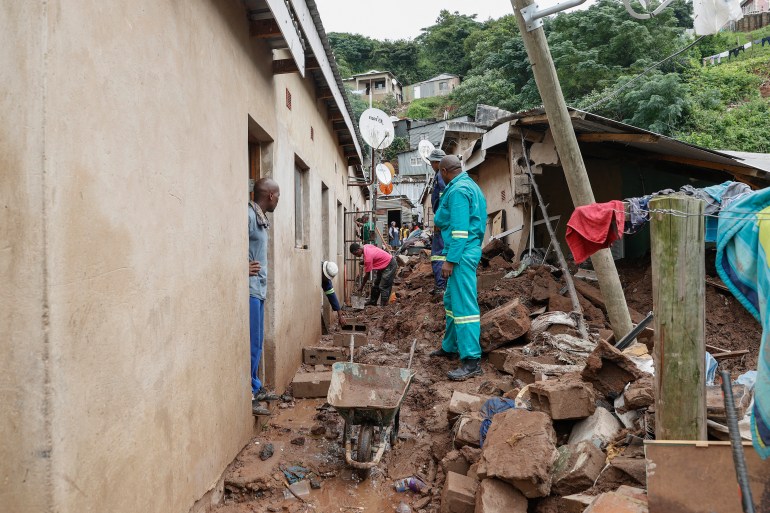 Residents salvage the remains of what used to be the United Methodist Church of South Africa in Clermont, near Durban, on April 13, 2022, following heavy rains that killed four children in the area