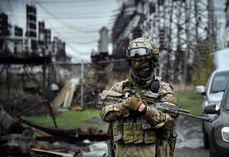 A Russian soldier is seen standing guard in Luhansk 