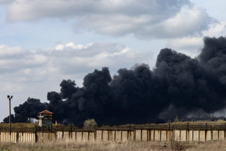 Smoke raises from an oil refinery in Lysychansk about 120km north of Donetsk